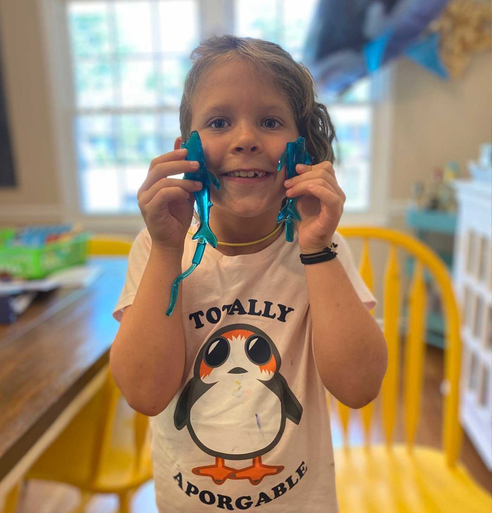 girl holding shark gummy candy for shark week